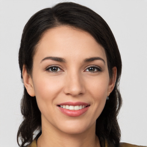 Joyful white young-adult female with long  brown hair and brown eyes