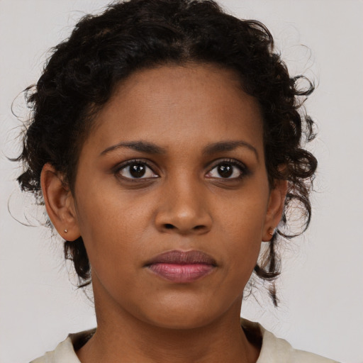 Neutral black young-adult female with medium  brown hair and brown eyes
