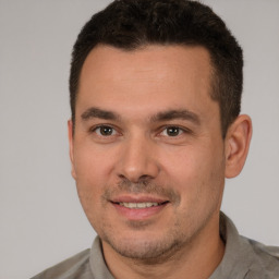 Joyful white young-adult male with short  brown hair and brown eyes