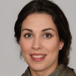 Joyful white adult female with medium  brown hair and brown eyes