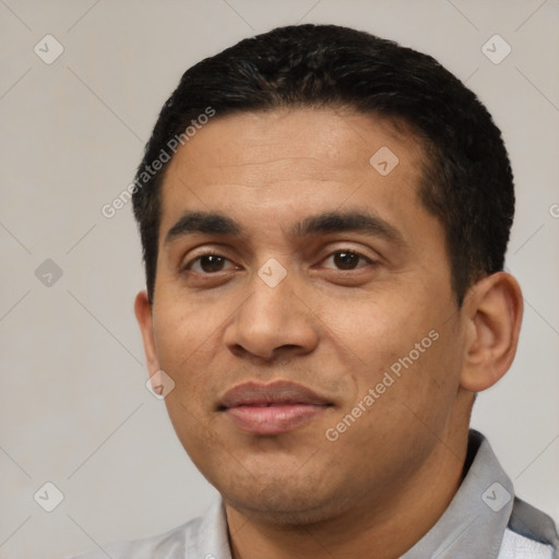 Joyful latino young-adult male with short  black hair and brown eyes