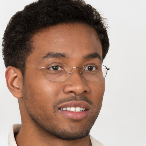 Joyful black young-adult male with short  brown hair and brown eyes