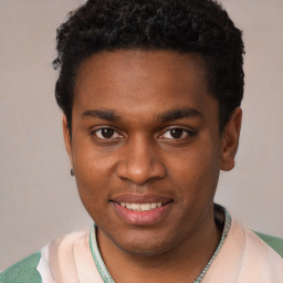 Joyful black young-adult male with short  black hair and brown eyes