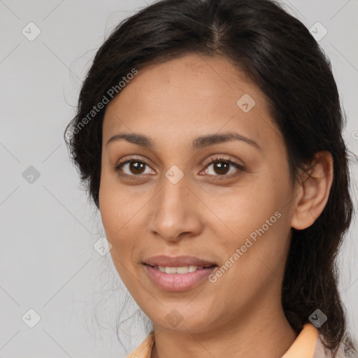 Joyful latino young-adult female with medium  brown hair and brown eyes