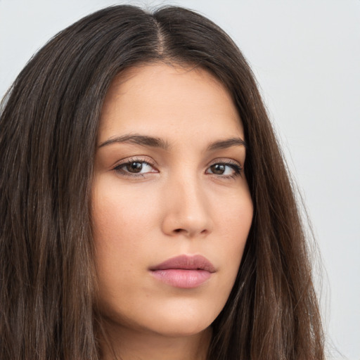 Neutral white young-adult female with long  brown hair and brown eyes