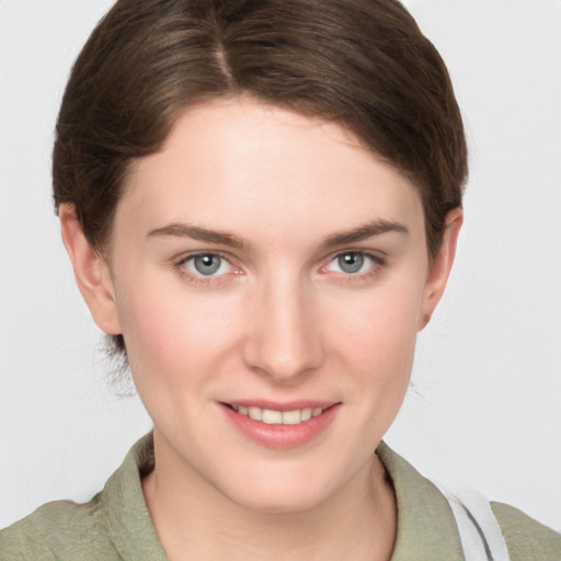 Joyful white young-adult female with short  brown hair and grey eyes