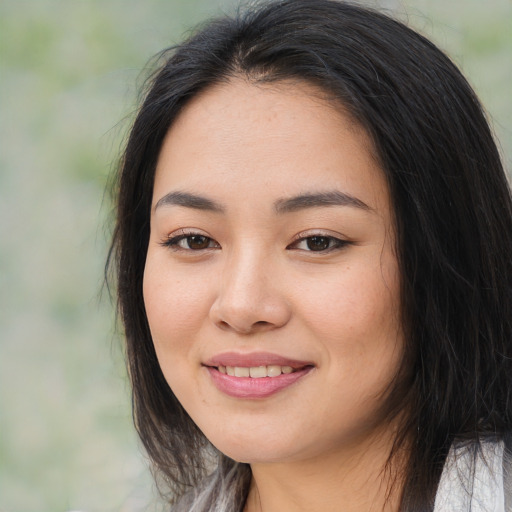 Joyful asian young-adult female with long  brown hair and brown eyes