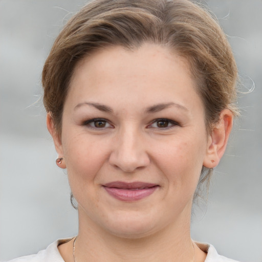 Joyful white young-adult female with medium  brown hair and grey eyes