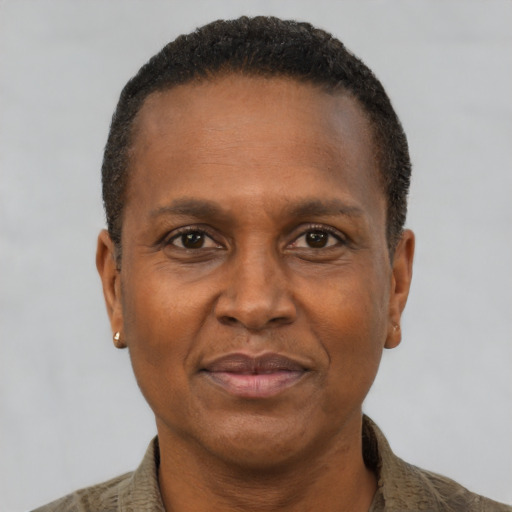 Joyful black adult male with short  brown hair and brown eyes