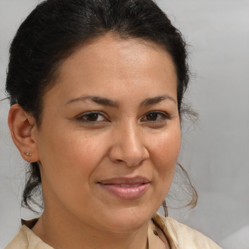 Joyful latino young-adult female with medium  brown hair and brown eyes