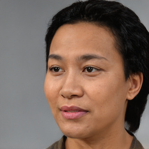 Joyful black adult female with medium  black hair and brown eyes