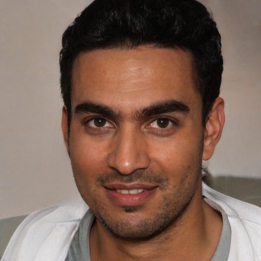Joyful white young-adult male with short  black hair and brown eyes