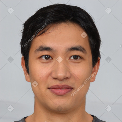 Joyful asian young-adult male with short  black hair and brown eyes