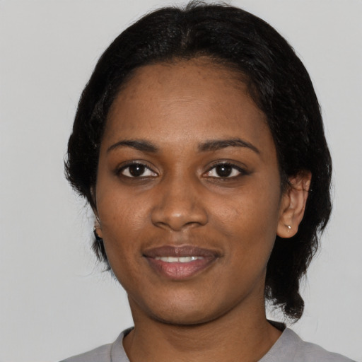 Joyful black young-adult female with medium  black hair and brown eyes