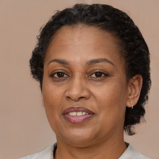 Joyful latino adult female with short  brown hair and brown eyes
