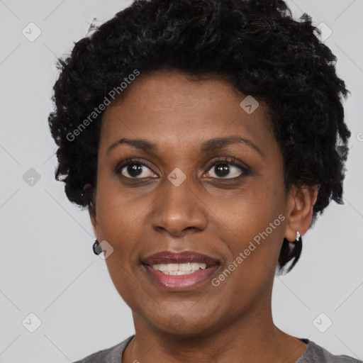 Joyful black adult female with short  brown hair and brown eyes