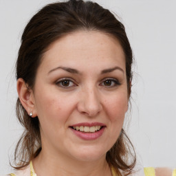 Joyful white young-adult female with medium  brown hair and brown eyes