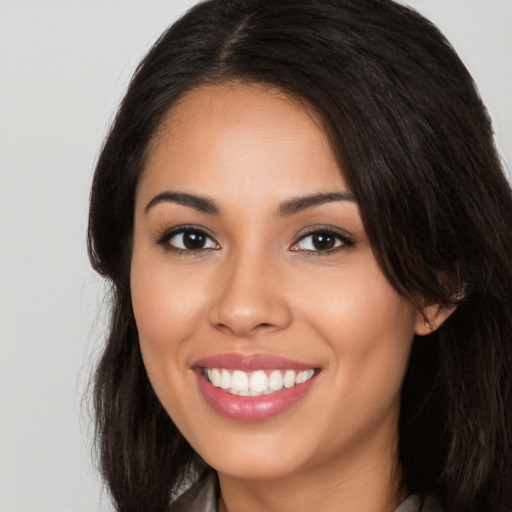 Joyful white young-adult female with long  black hair and brown eyes