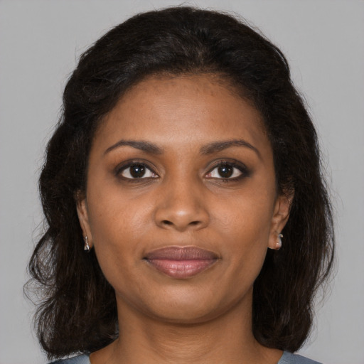Joyful black young-adult female with medium  brown hair and brown eyes