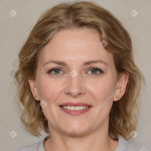 Joyful white adult female with medium  brown hair and blue eyes