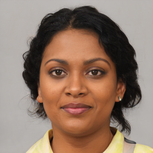 Joyful black young-adult female with medium  black hair and brown eyes