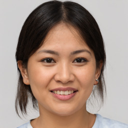 Joyful white young-adult female with medium  brown hair and brown eyes