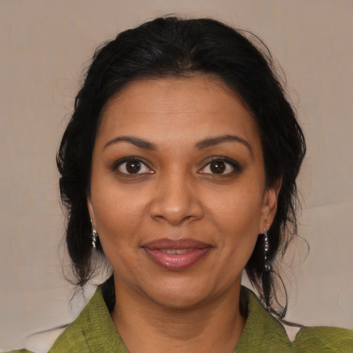 Joyful black adult female with medium  brown hair and brown eyes