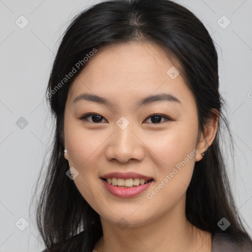 Joyful asian young-adult female with long  brown hair and brown eyes