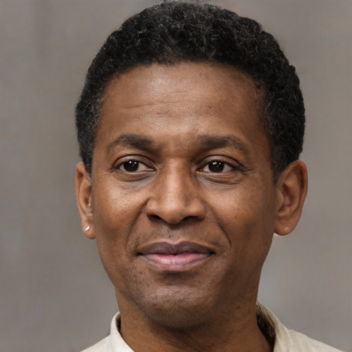Joyful black adult male with short  black hair and brown eyes