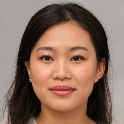 Joyful asian young-adult female with medium  brown hair and brown eyes