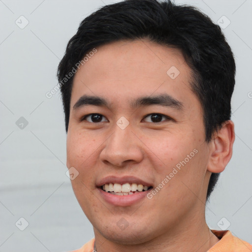 Joyful asian young-adult male with short  black hair and brown eyes