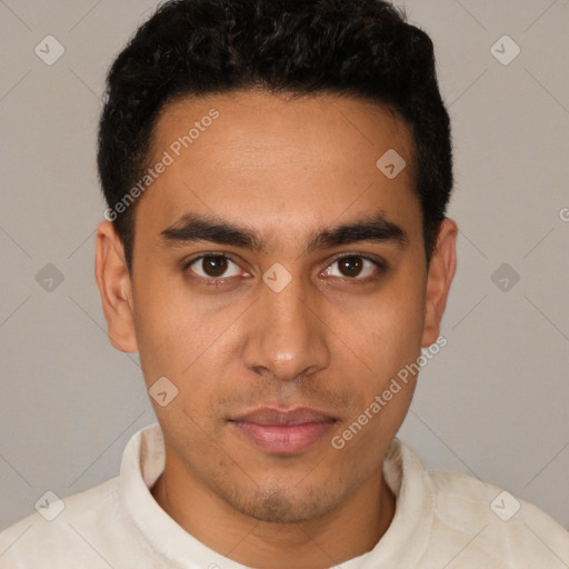 Joyful latino young-adult male with short  brown hair and brown eyes