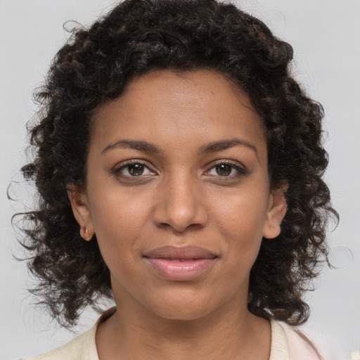 Joyful black young-adult female with medium  brown hair and brown eyes