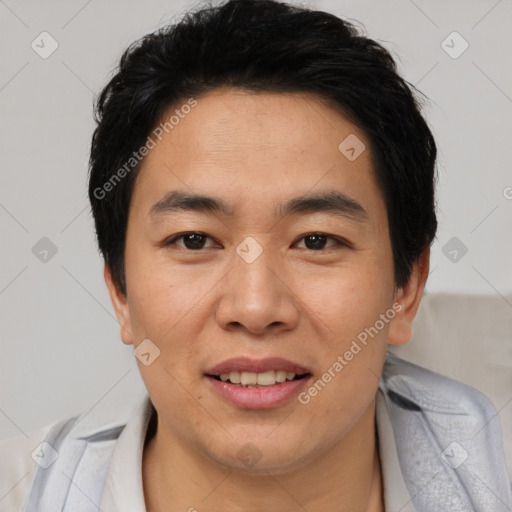 Joyful asian young-adult male with short  black hair and brown eyes