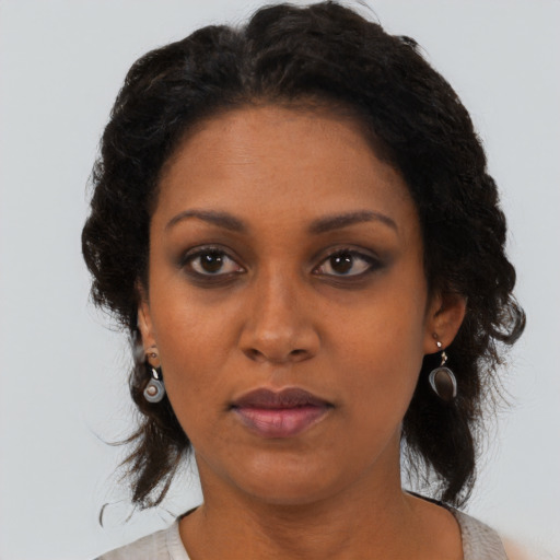 Neutral black adult female with medium  brown hair and brown eyes
