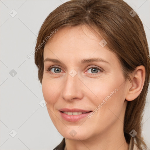 Joyful white adult female with medium  brown hair and grey eyes