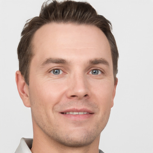 Joyful white adult male with short  brown hair and grey eyes