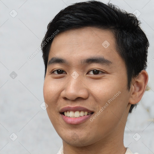 Joyful asian young-adult male with short  brown hair and brown eyes