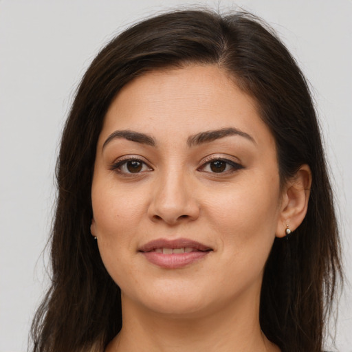Joyful white young-adult female with long  brown hair and brown eyes