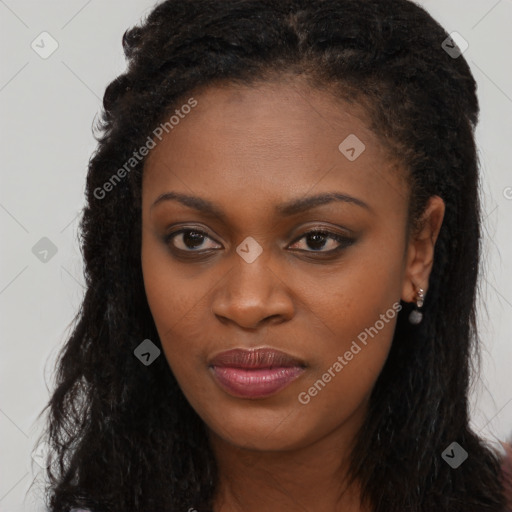 Joyful black young-adult female with long  brown hair and brown eyes