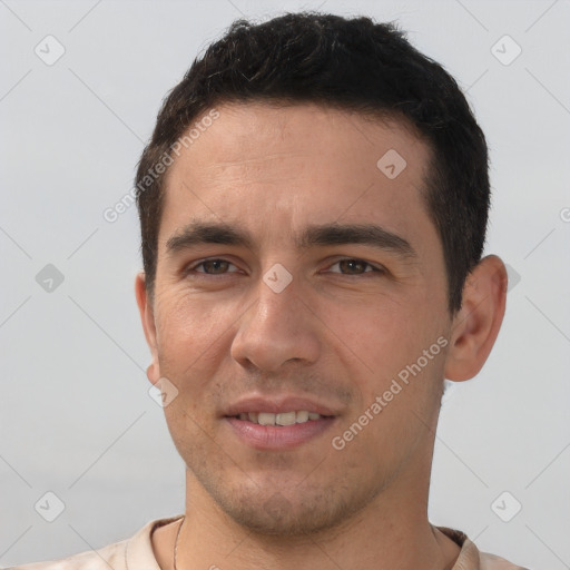 Joyful white young-adult male with short  brown hair and brown eyes