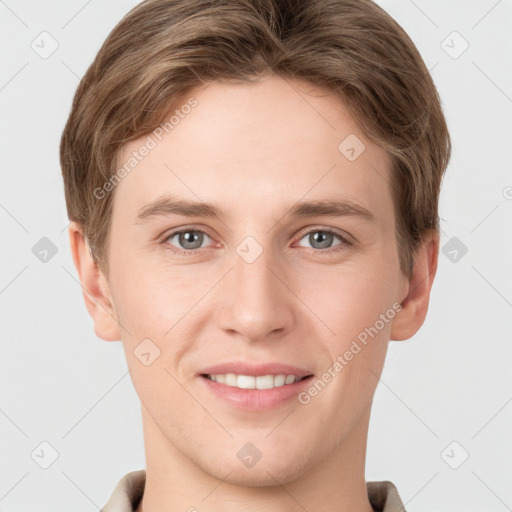 Joyful white young-adult male with short  brown hair and grey eyes