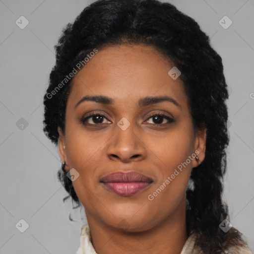 Joyful black young-adult female with long  black hair and brown eyes