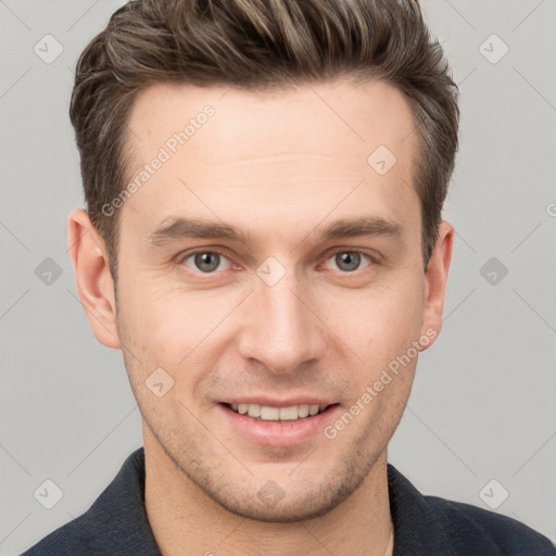 Joyful white young-adult male with short  brown hair and grey eyes