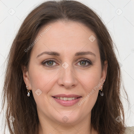 Joyful white adult female with long  brown hair and grey eyes