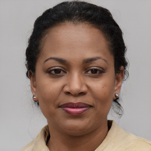 Joyful latino adult female with medium  brown hair and brown eyes