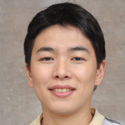 Joyful asian young-adult male with short  brown hair and brown eyes