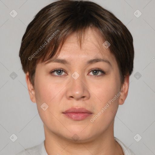 Joyful asian young-adult female with short  brown hair and brown eyes