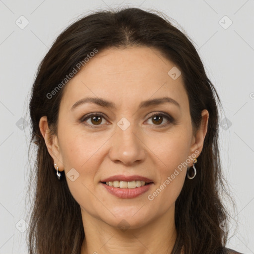 Joyful white adult female with long  brown hair and brown eyes