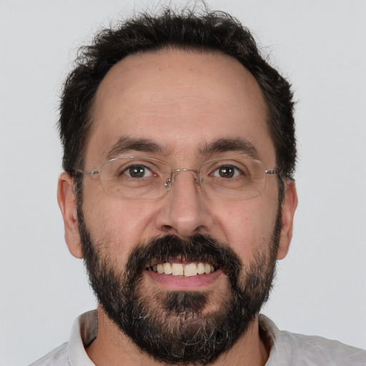 Joyful white adult male with short  brown hair and brown eyes